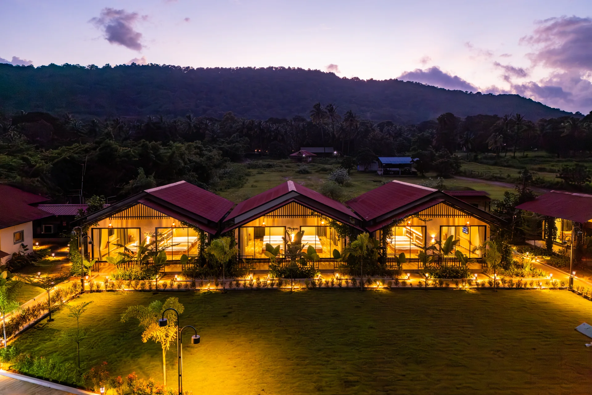 Warm cottage lights at dusk at Nadi Teera, Dandeli