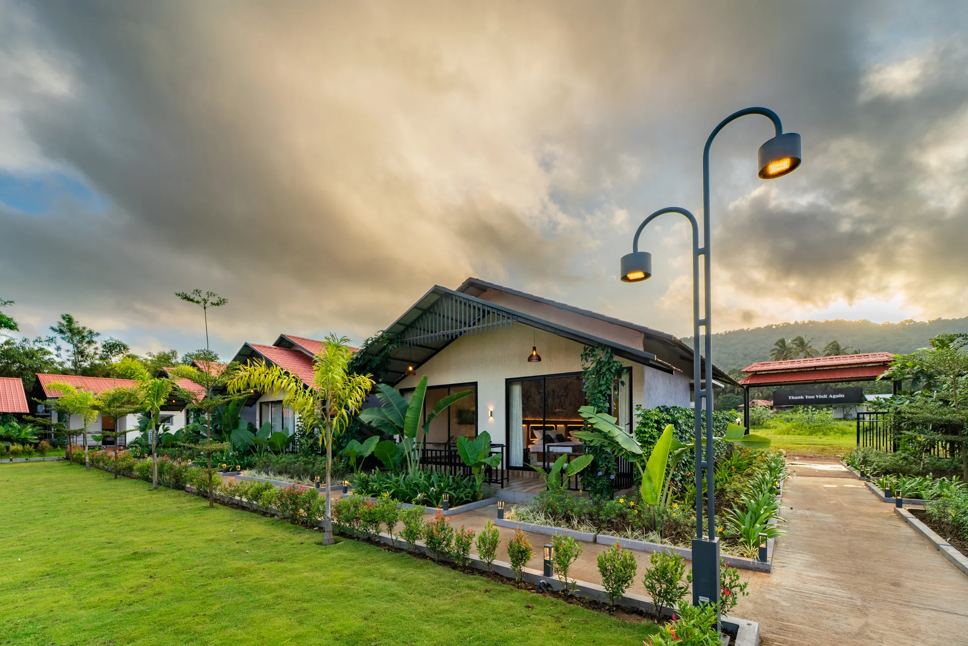 Cottage veranda beside the lawn at Nadi Teera, Dandeli