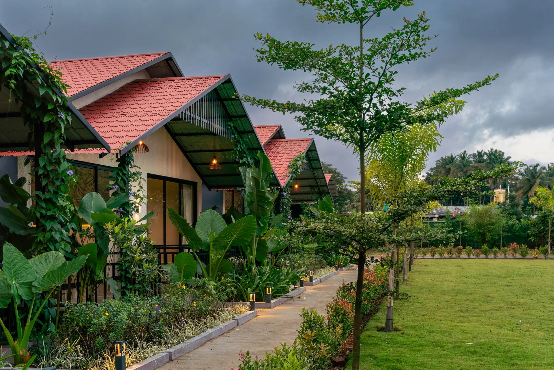 Cottages along the garden path at Nadi Teera, Dandeli