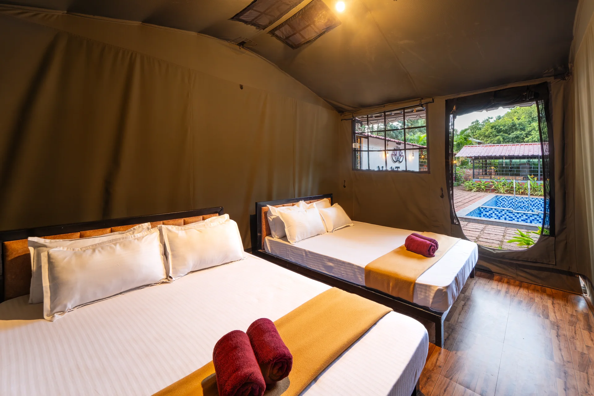 Commando Cottage beds and pool view at Nadi Teera, Dandeli