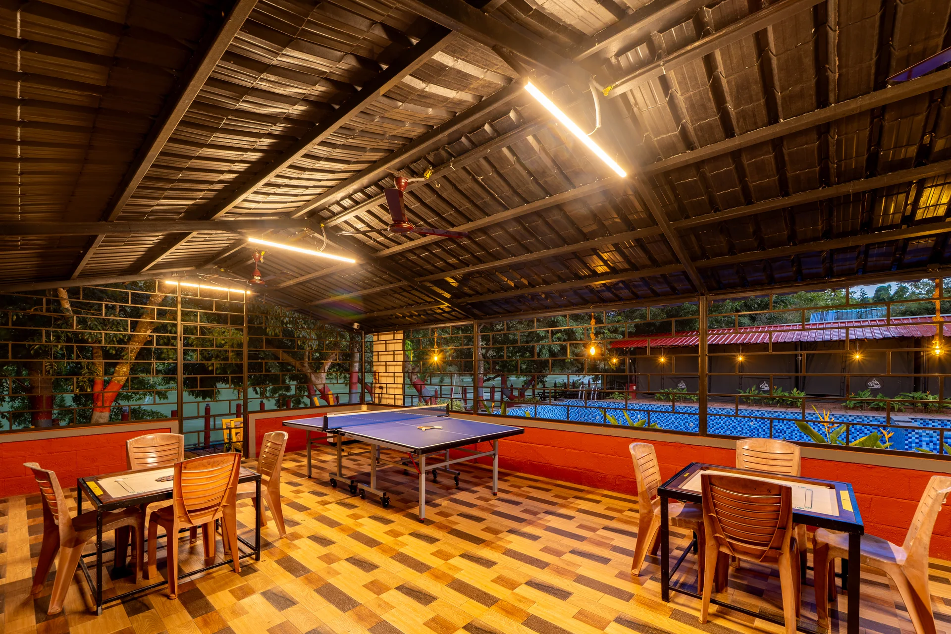 Poolside dining and games at Nadi Teera, Dandeli